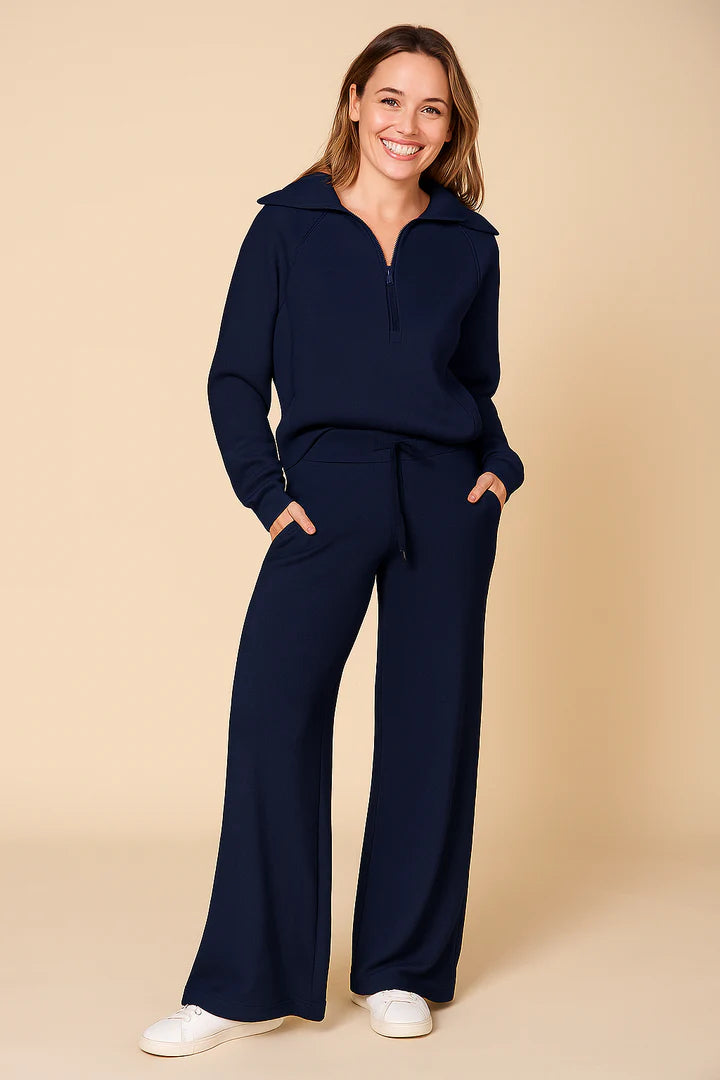 Tvådelat set för dam med halvlång dragkedja och vida byxor