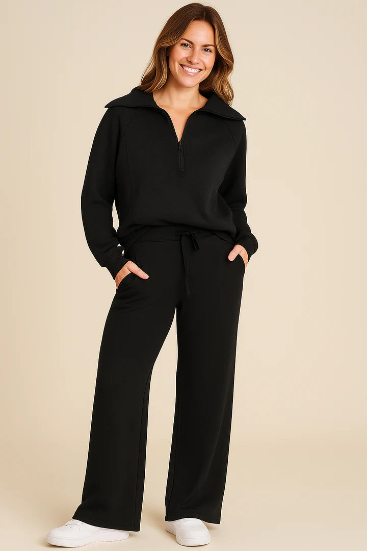 Tvådelat set för dam med halvlång dragkedja och vida byxor